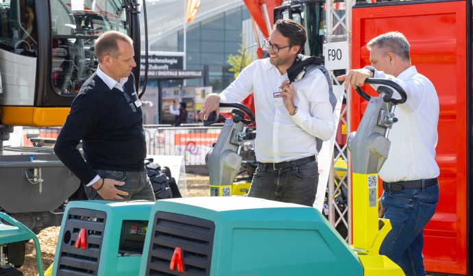 Exhibitors speak at a stand