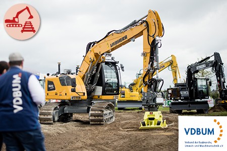 A yellow excavator presents an earth auger 